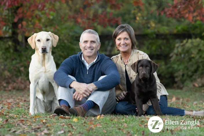 Photo of couple and their two dogs taken in the fall in Loudoun County VA by Ellen Zangla Photography