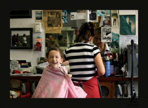 Photo of young boy getting a haircut in Leesburg VA by Ellen Zangla Photography