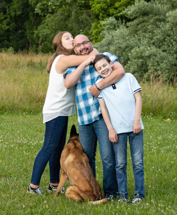 Family having fun during their outdoor portrait session with their dog in Northern Virginia.