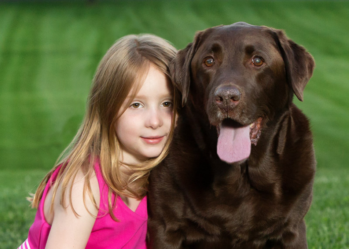 Young girl sitting outside with her face next to her Chocolate Lab in Northern Virginia.