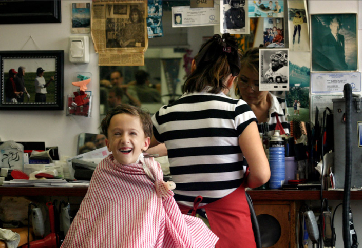Happy boy laughing while getting a haircut in Leesburg, VA.