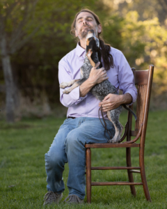 Dog handler holding a puppy doing an outdoor puppy shoot in Northern Virginia.