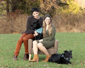 Photo of a family with two black dogs outdoors in Loudoun County