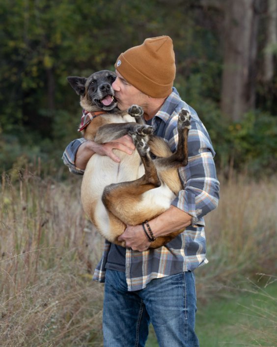 Man Hugging Belgian Malinois | Loudoun County, VA Man holding his Belgian Malinois and hugging her in a field in Loudoun County.