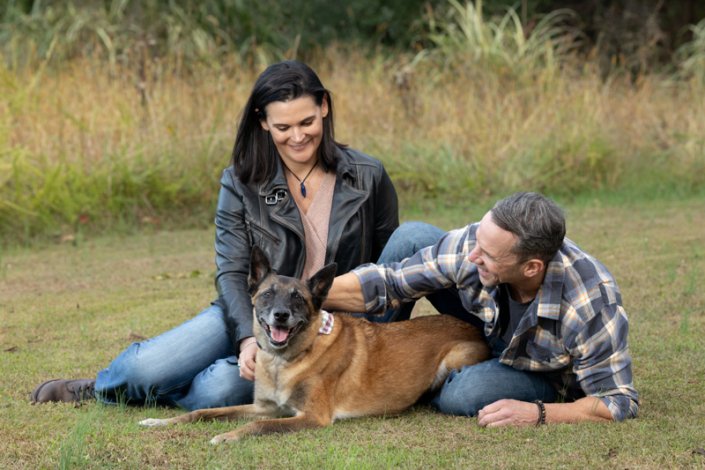 Couple and Belgian Malinois Outside | Loudoun County Couple lying outside in the grass with their Belgian Malinois.