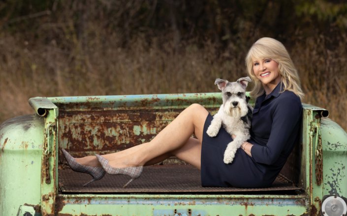 Schnauzer and Woman Outside in Antique Truck Woman sitting outside in antique truck with Schnauzer.
